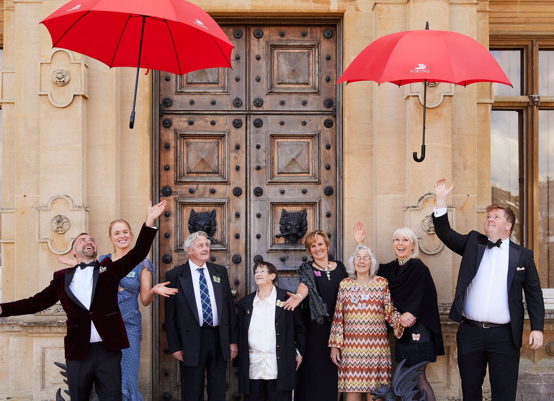 Group celebration with red umbrellas outdoors
