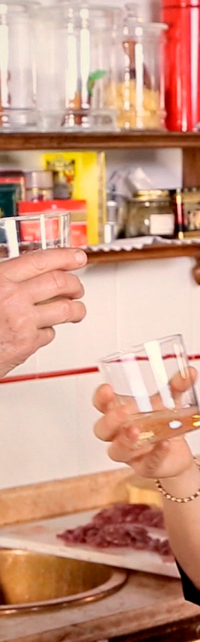 Two women toasting in a kitchen