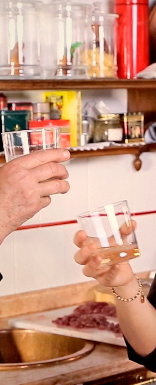 Two women toasting in a kitchen