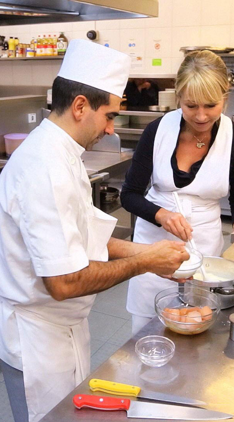 Chefs preparing food in a commercial kitchen