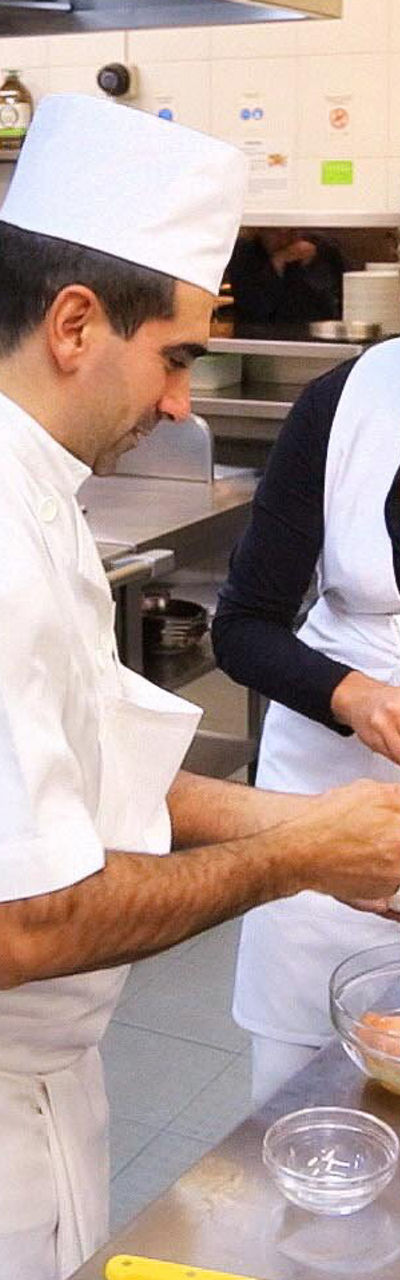 Chefs preparing food in a commercial kitchen
