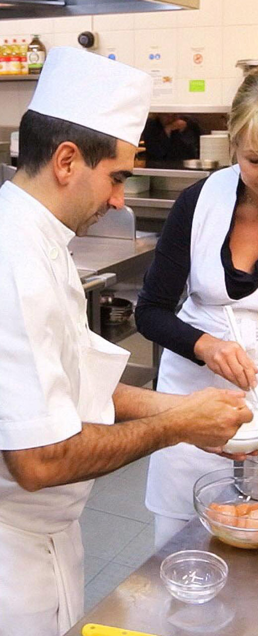 Chefs preparing food in a commercial kitchen