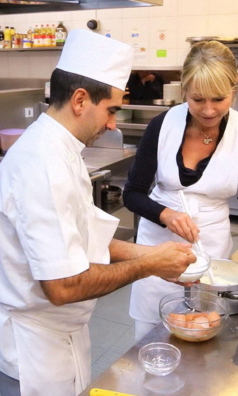 Chefs preparing food in a commercial kitchen