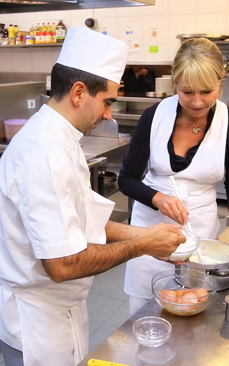 Chefs preparing food in a commercial kitchen
