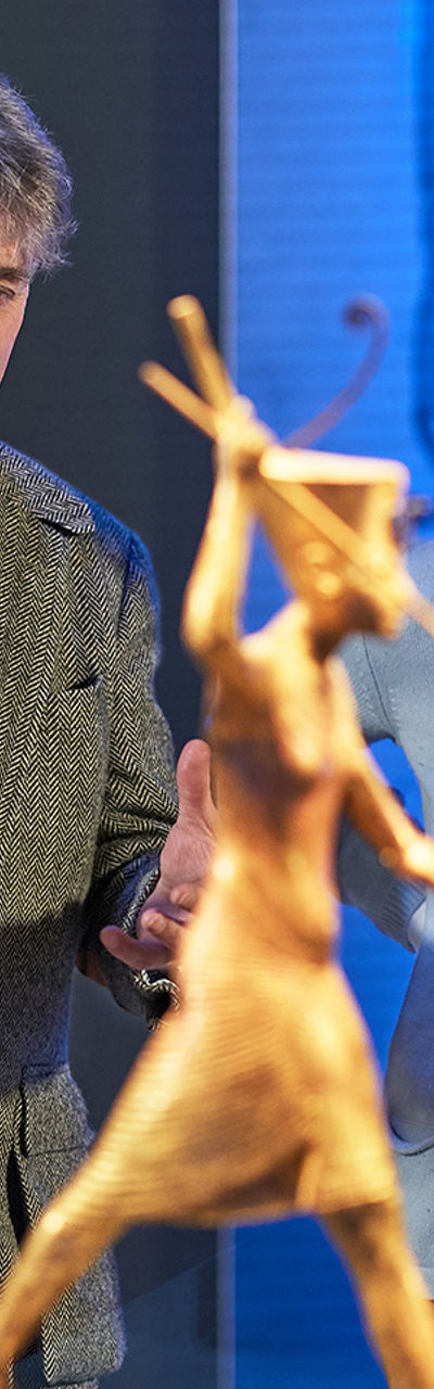 Museum visitors admire ancient sculpture