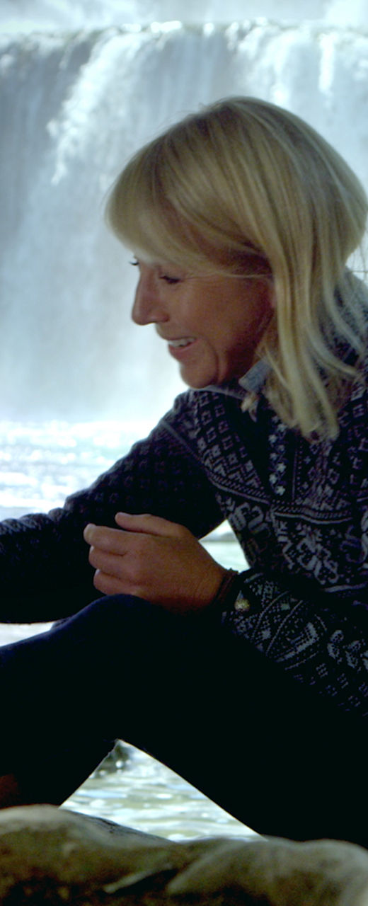 Woman with dog near waterfall outdoors