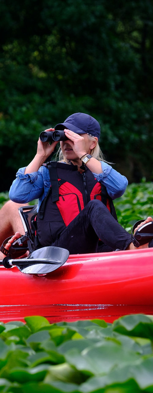 Red kayak with two people exploring nature
