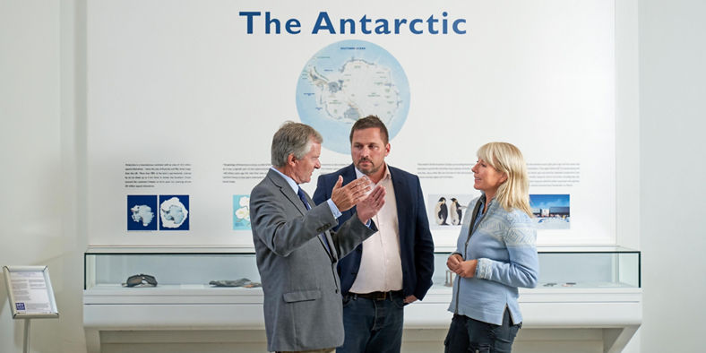 People discussing exhibit on the Antarctic