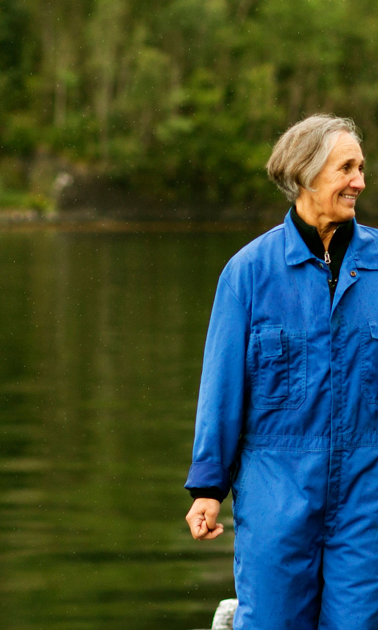 Two people walking on dock near lake