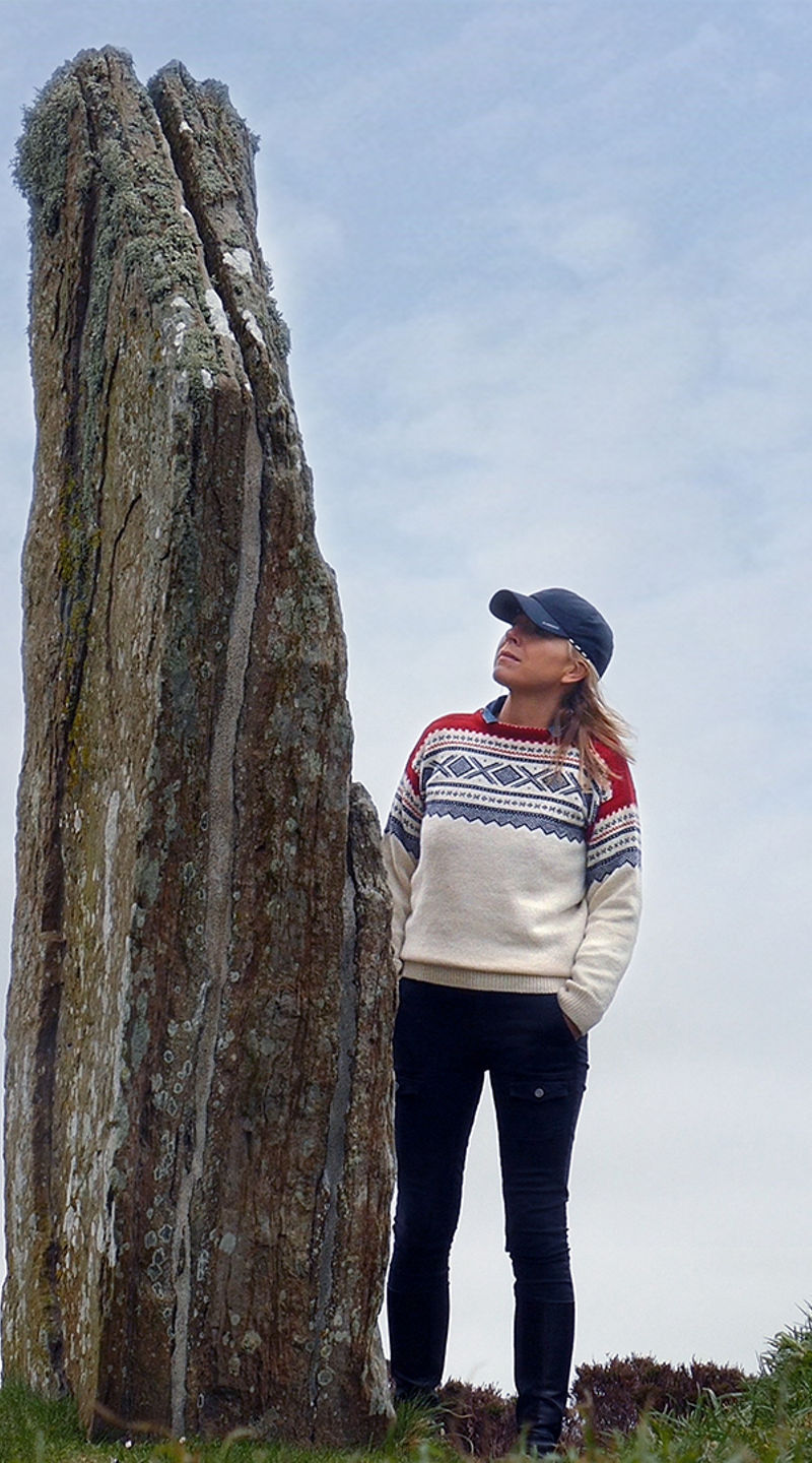 Woman exploring ancient stone circle outdoors