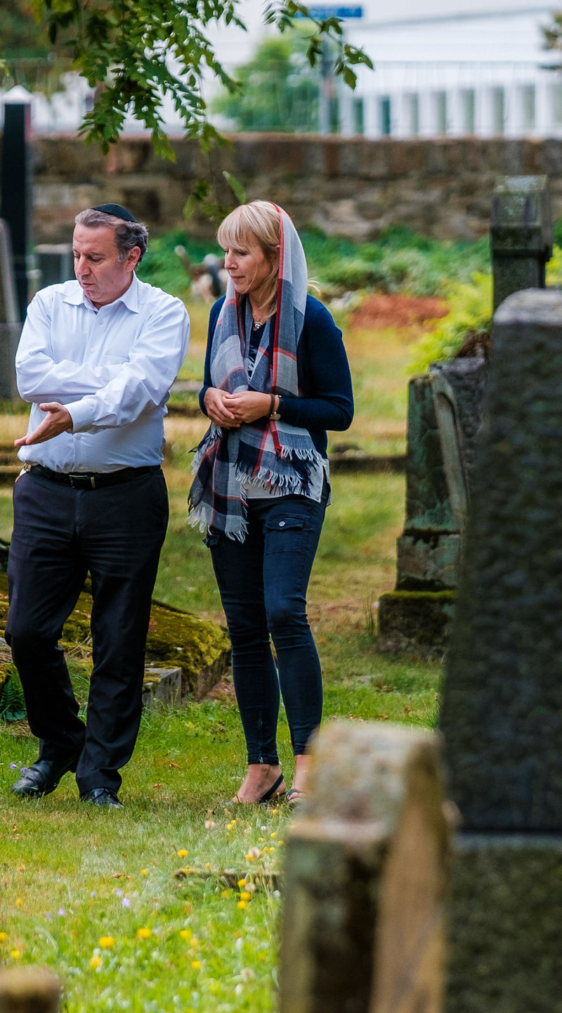 Two people walking in a cemetery