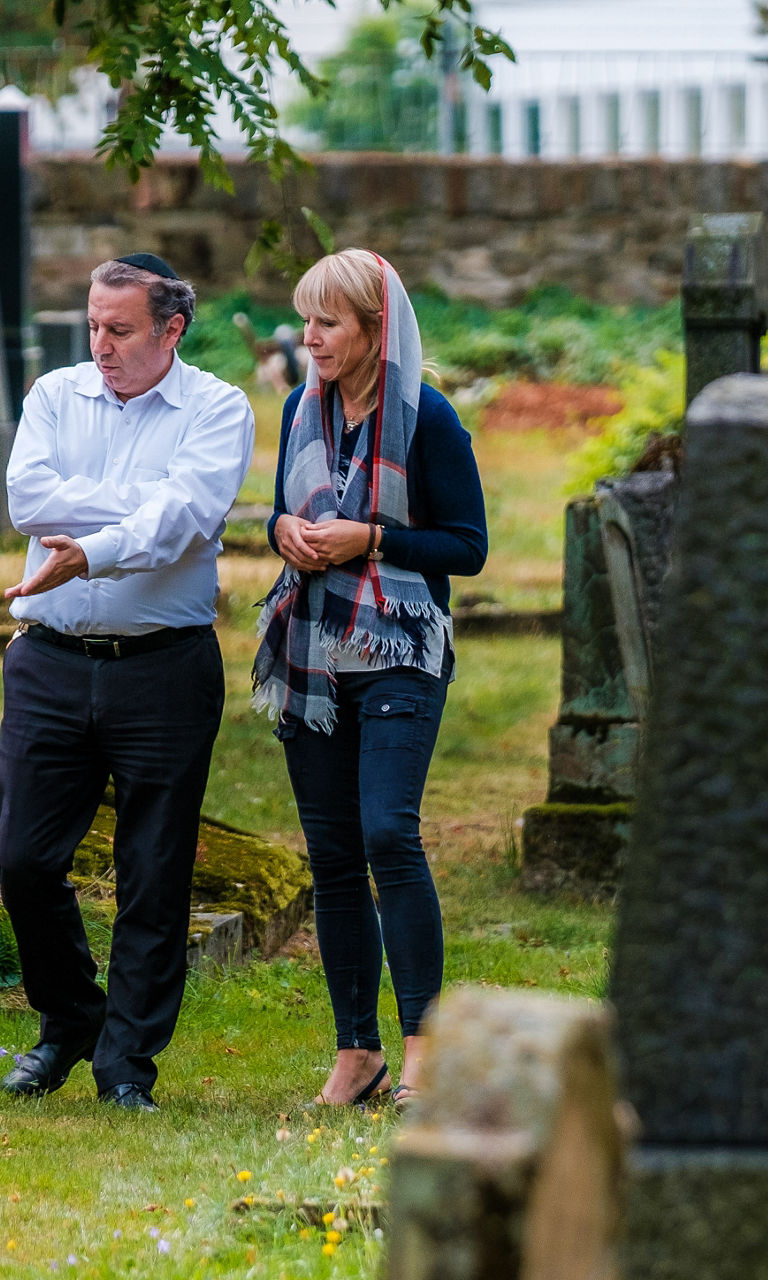 Two people walking in a cemetery