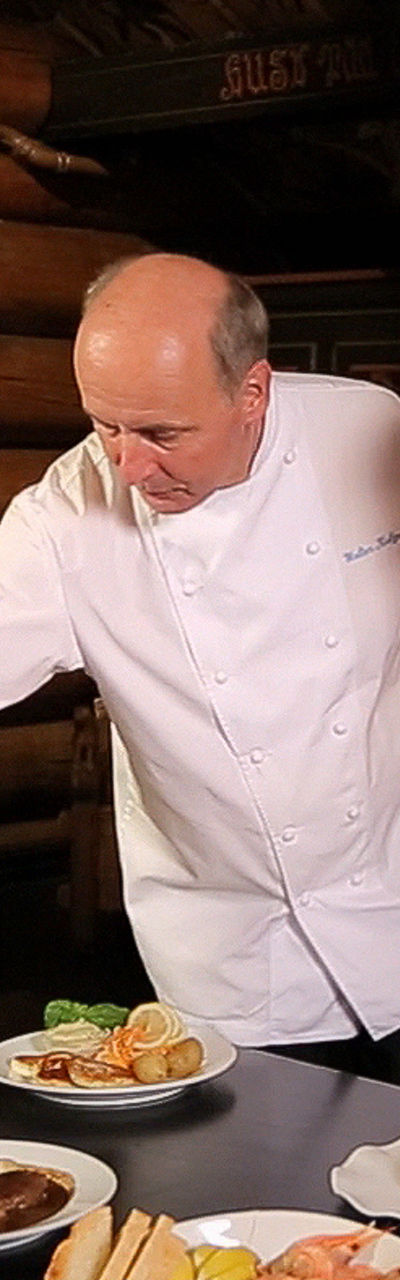 Chef presenting dishes in rustic setting
