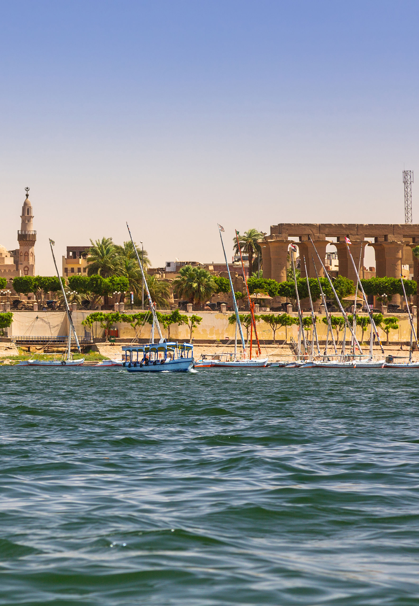 Luxor riverside with ancient ruins and boats