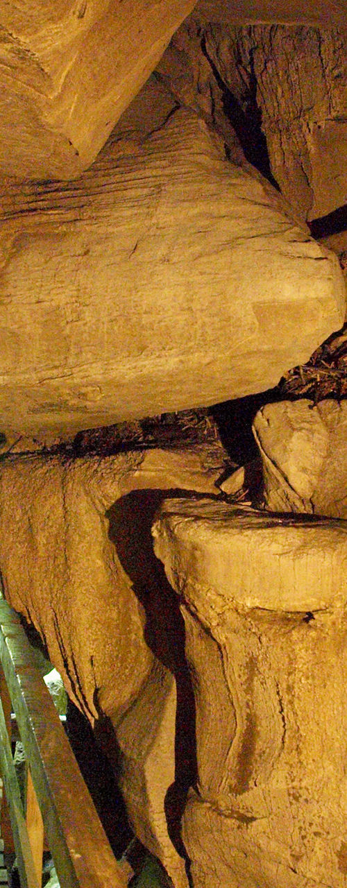 Wooden walkway inside natural rock cave