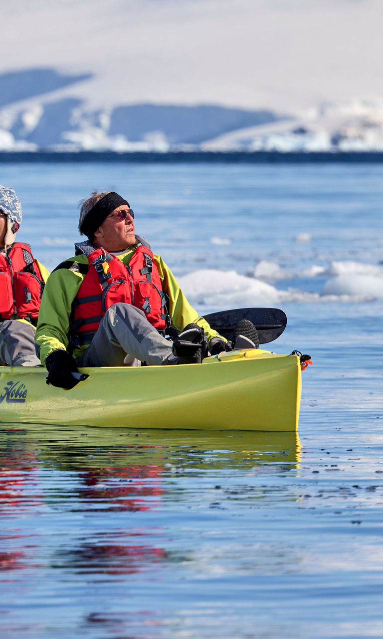 Two kayakers in icy Antarctic waters