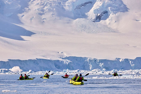Group kayaking in icy polar waters