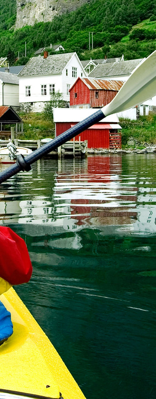Kayaker exploring scenic Nordic village