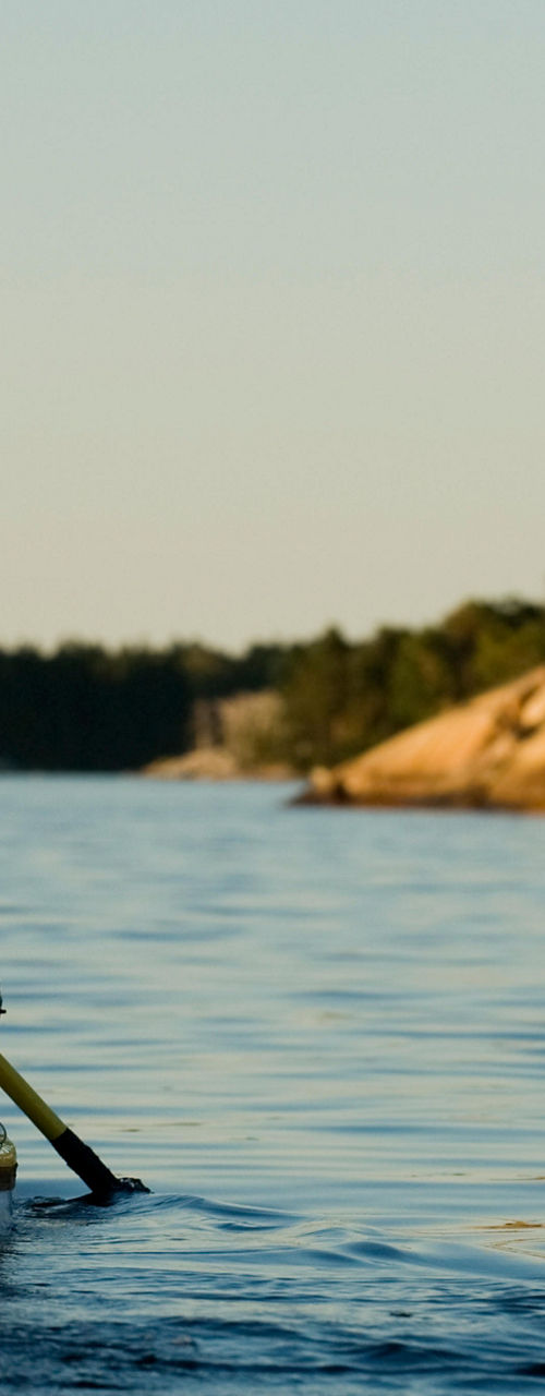 Solo kayaker paddling in serene waters