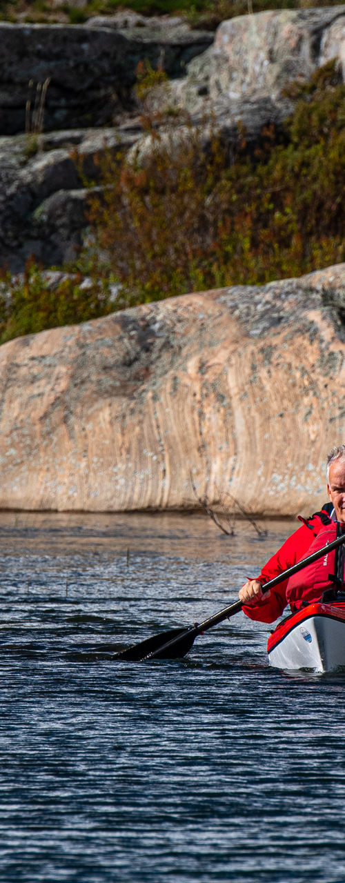 Man kayaking through rocky waterscape