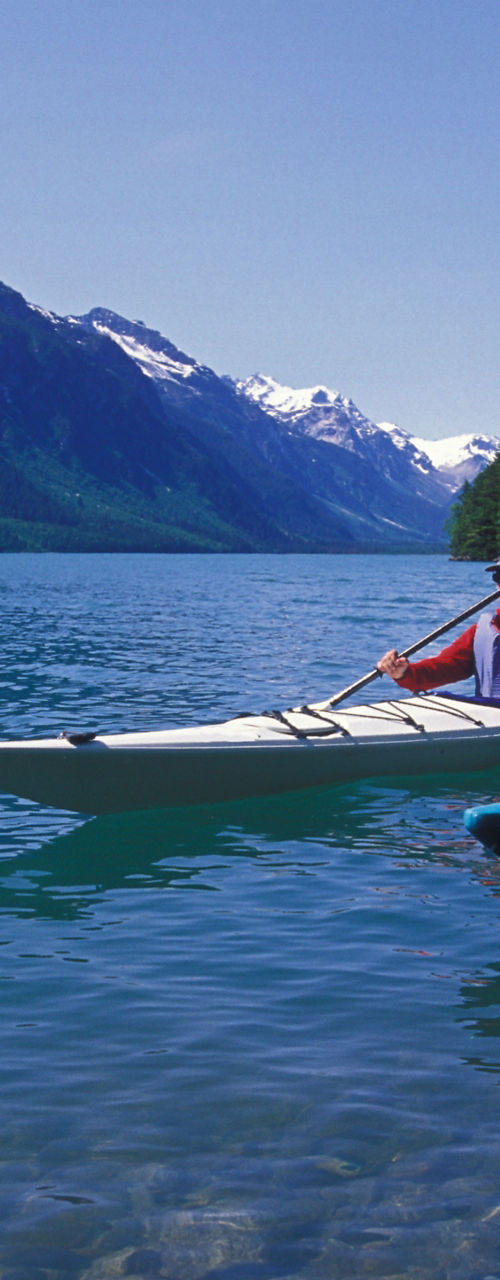 Two kayakers on scenic mountain lake