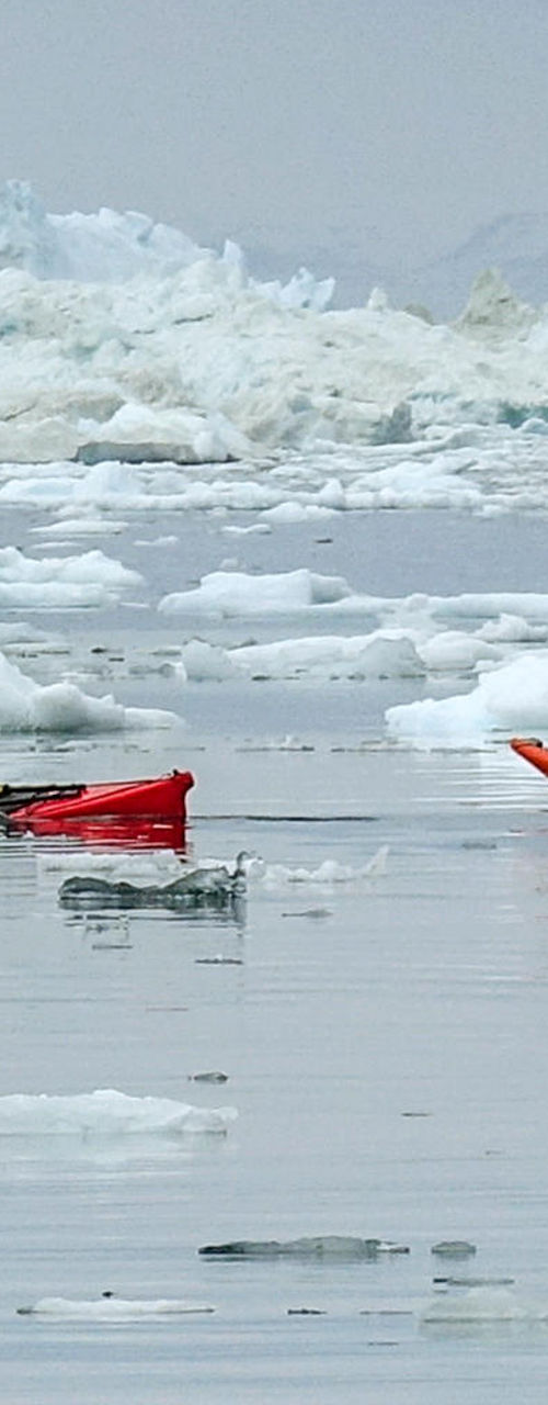Kayakers navigating icy Arctic waters