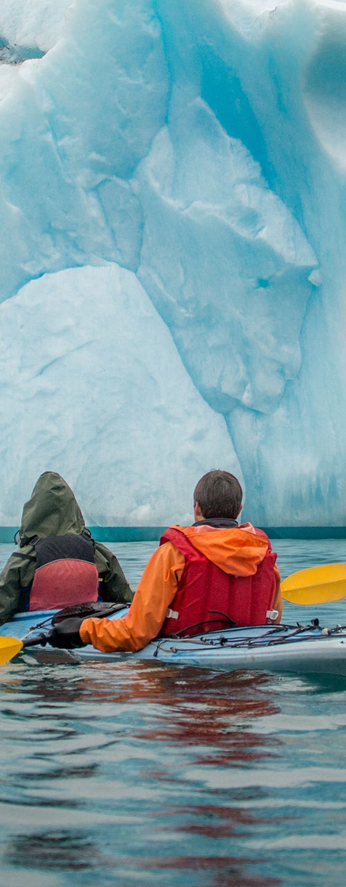 Two kayakers exploring icy waters