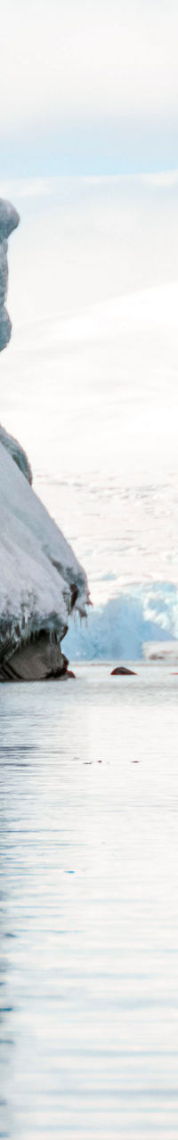 Two kayakers exploring icy Antarctic waters