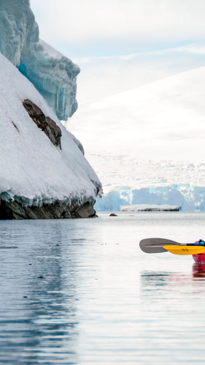 Two kayakers exploring icy Antarctic waters