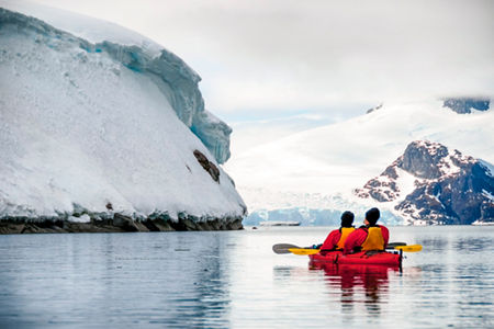 Two kayakers exploring icy Antarctic waters
