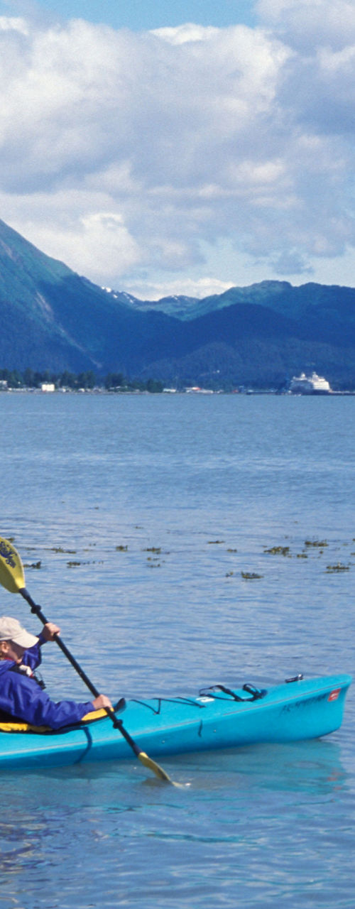Two kayakers in scenic mountain lake