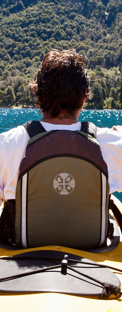Man kayaking on scenic mountain lake