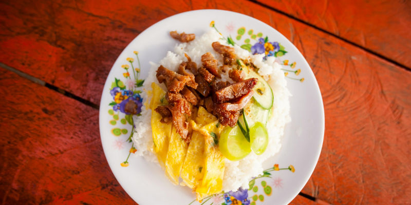 Rice dish with egg and grilled meat