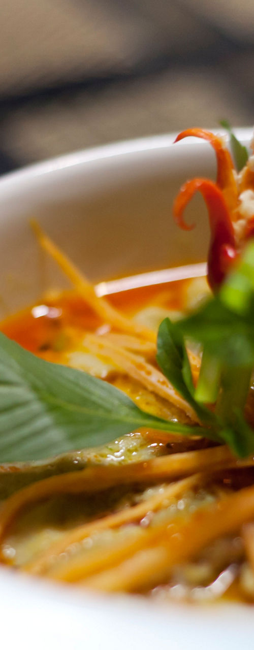 Bowl of Thai curry with fresh garnish