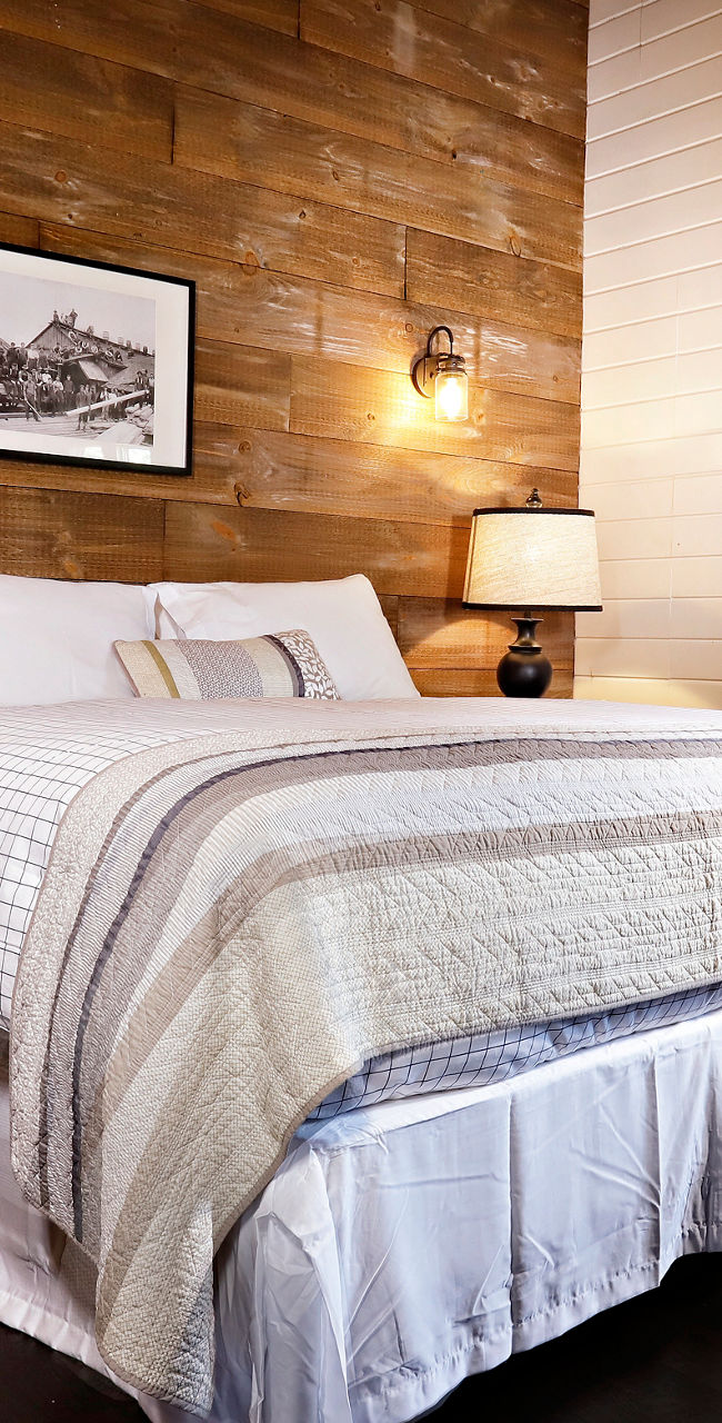 Cozy rustic bedroom with wooden walls