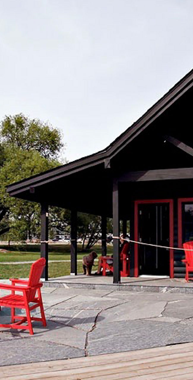 Outdoor cafe with red chairs and sign