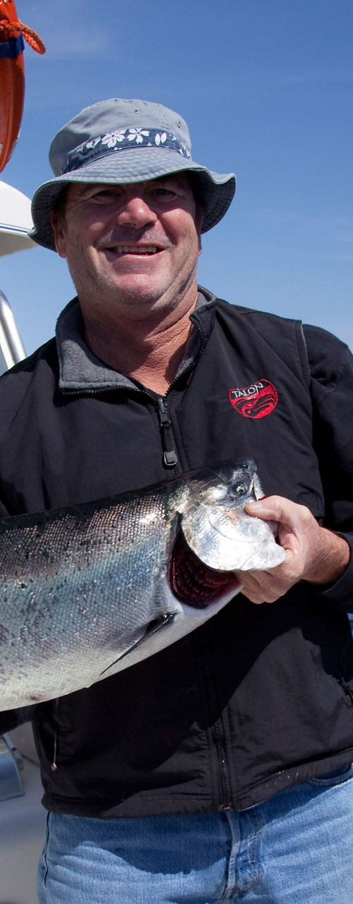 Man holding large fish on fishing boat