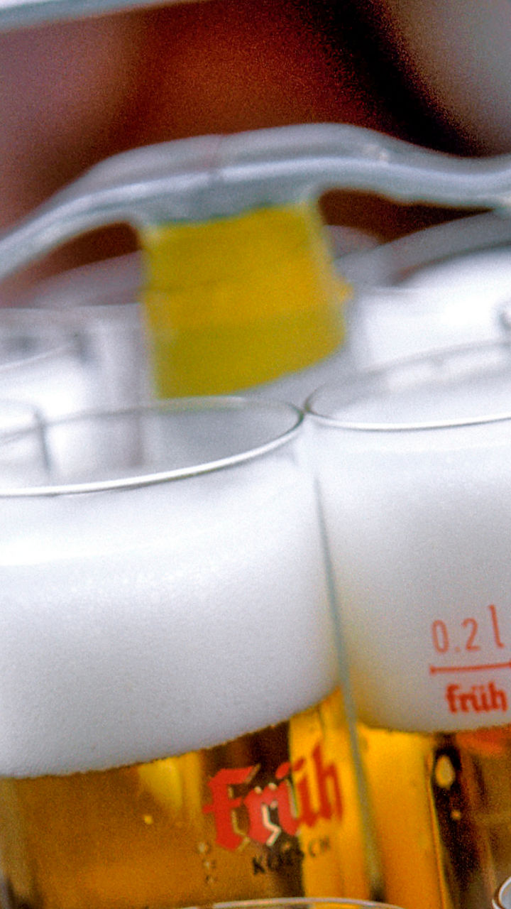 Tray of beer glasses with foam tops