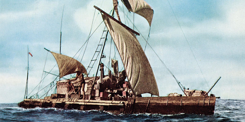 Wooden raft with sails on open sea