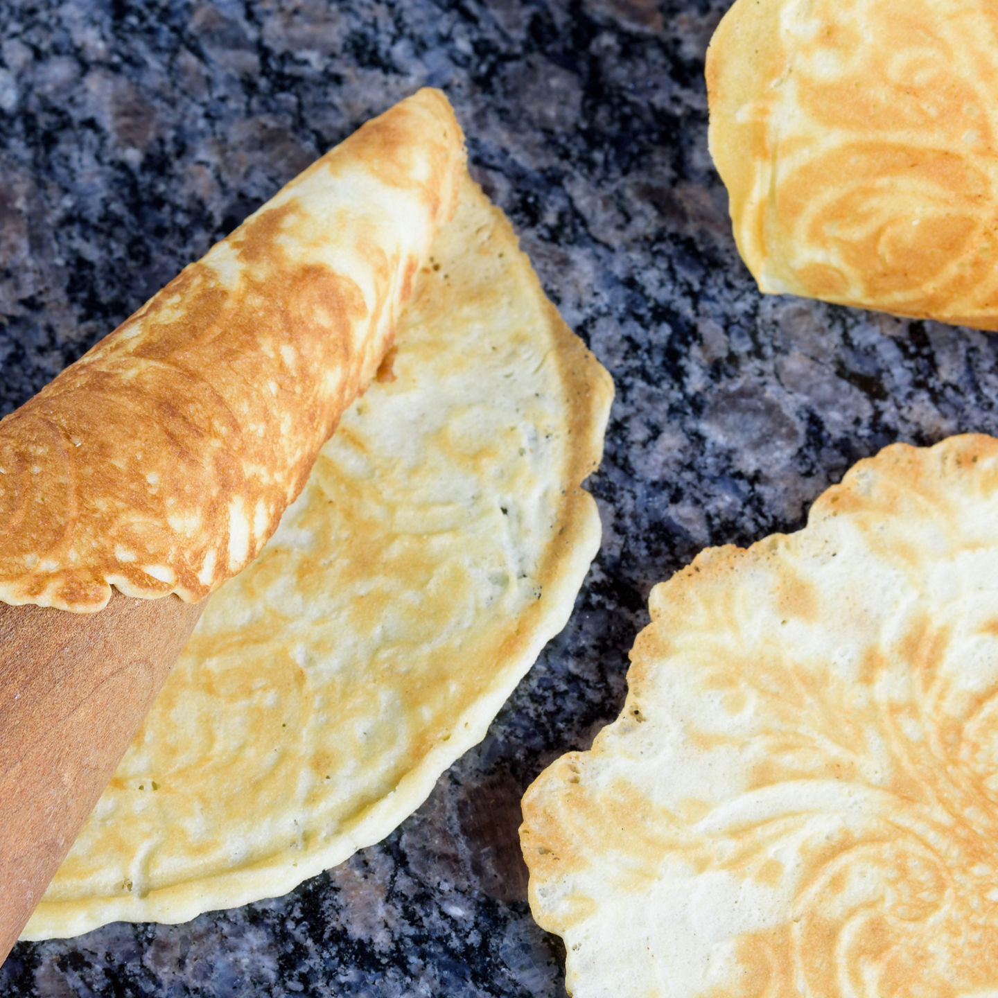Thin golden crepes on granite surface
