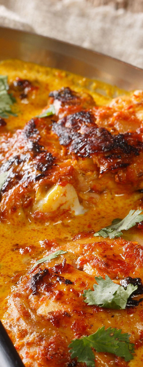 Spicy baked chicken curry in copper dish