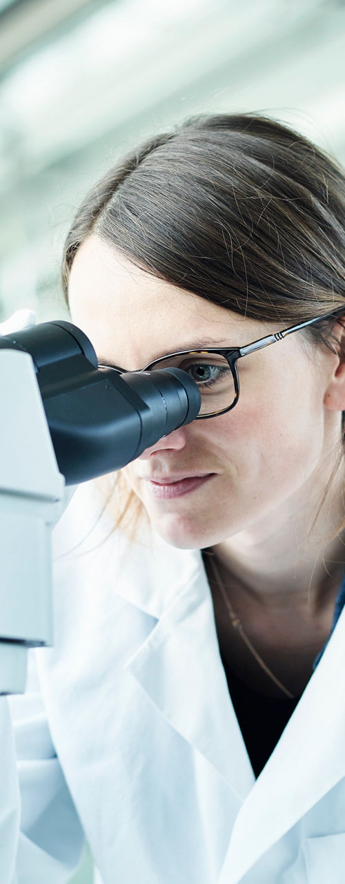 Scientist using microscope in laboratory