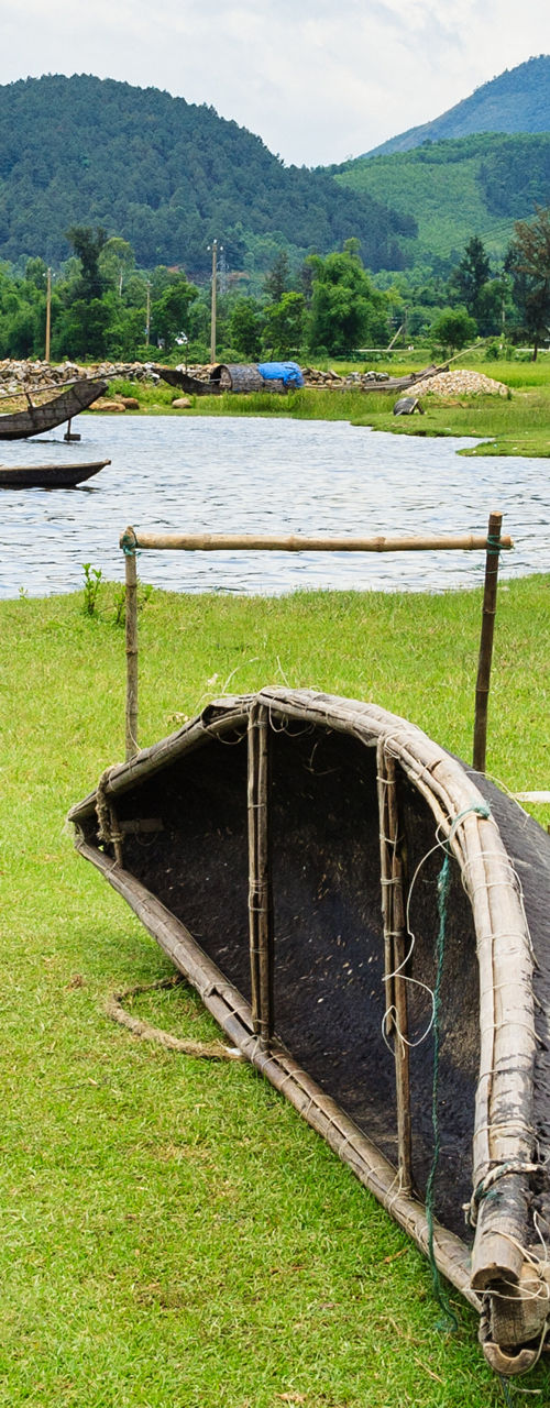 Traditional fishing boats on grassy lakeside