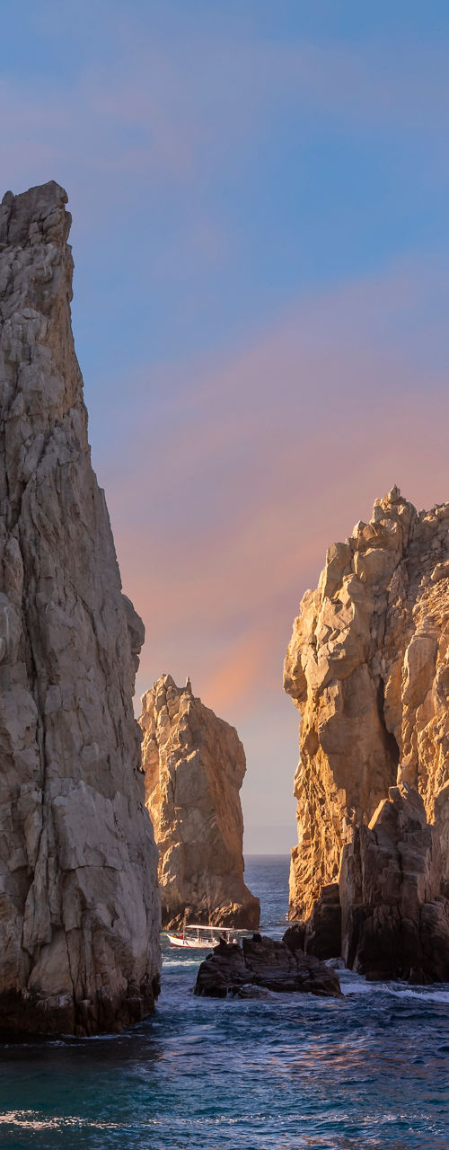 Rock formations at sunset over ocean