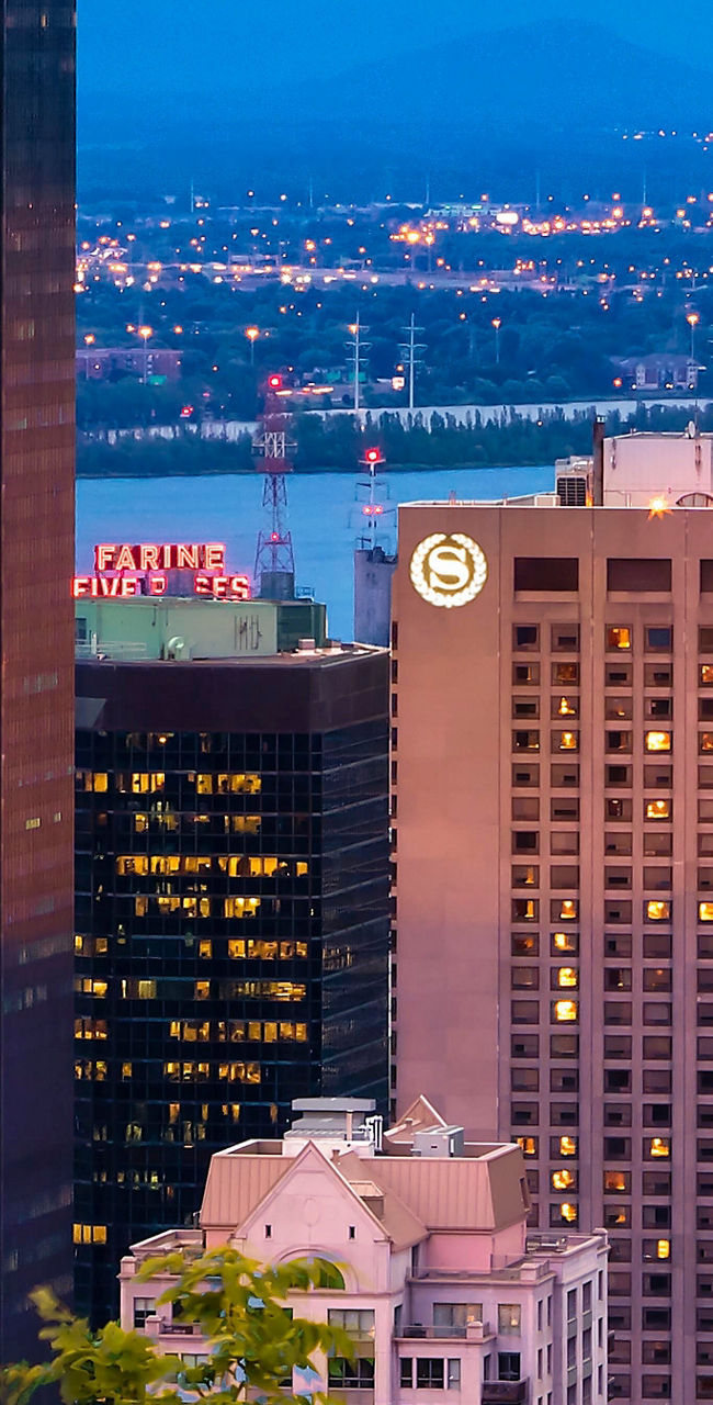 City skyline at dusk with illuminated buildings