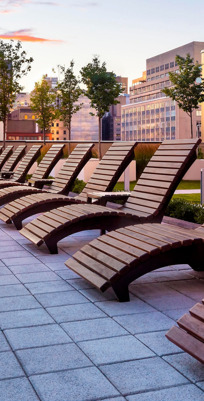 Modern rooftop lounge with wooden chairs