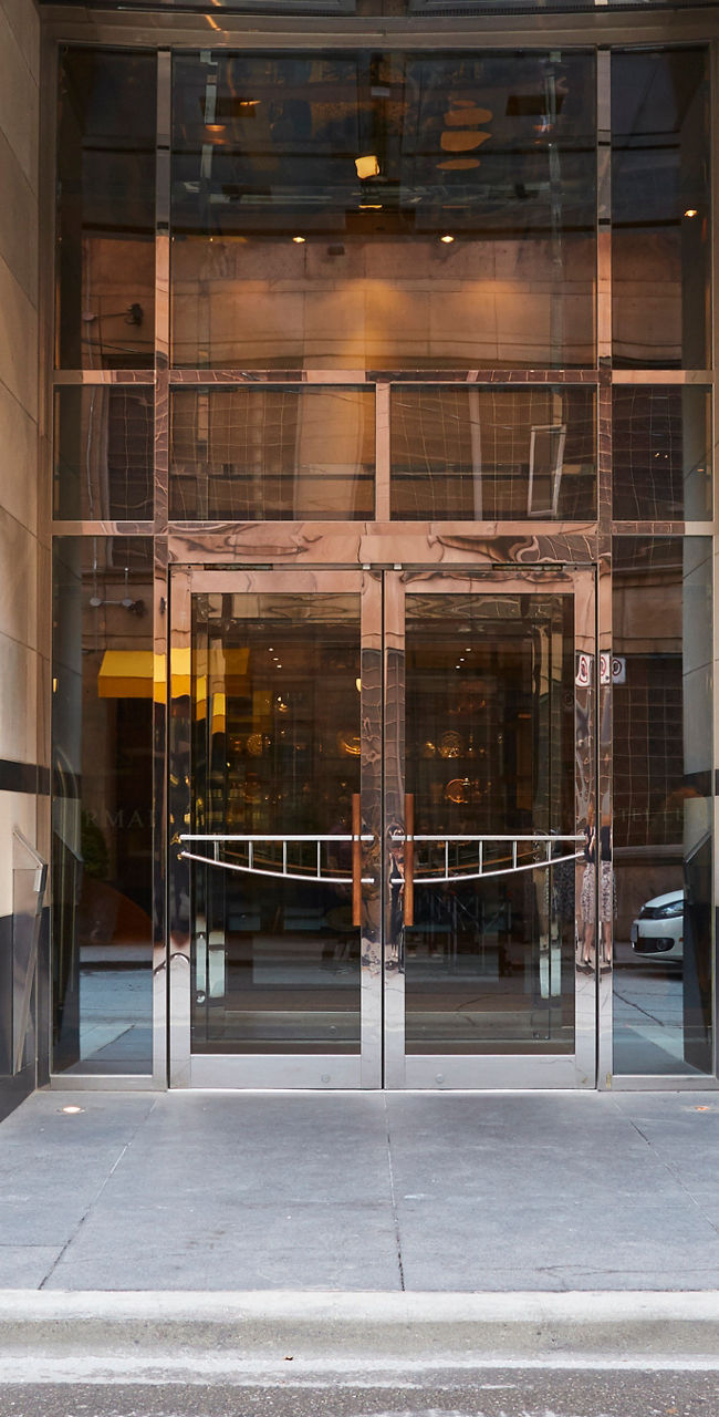 Modern glass building entrance with revolving doors
