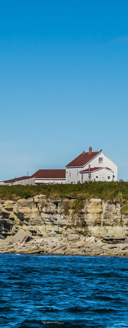 Coastal lighthouse on rocky cliffside