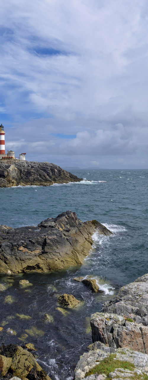 Scenic lighthouse on rocky coastal landscape