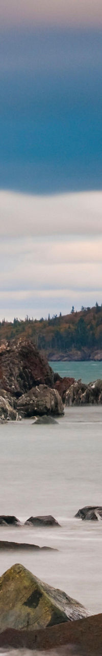 Scenic lighthouse by rocky coastal shore
